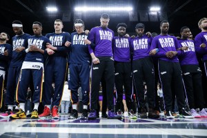 Sacramento Kings and Denver Nuggets players gather for a moment of silence